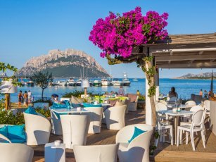 Strand Restaurant in San Teodoro bei Olbia, im Hintergund Boote und die Insel Tavolara Strand Restaurant in San Teodoro bei Olbia, im Hintergund Boote und die Insel Tavolara
